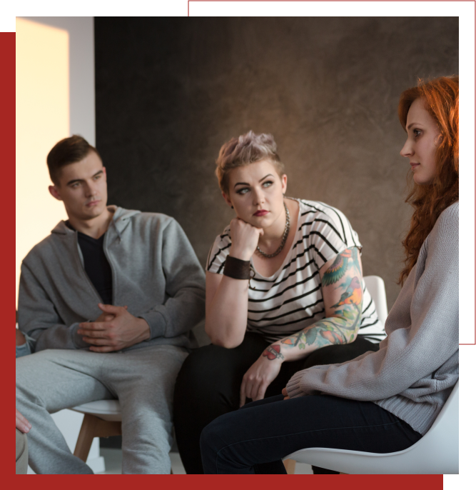 Young adults seated and speaking with a female